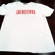 White t-shirt with red letters reading ABCDEFEMME